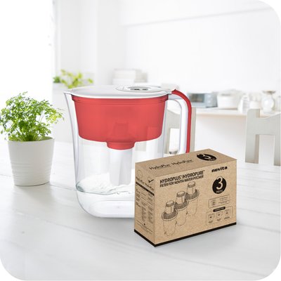A HydroPlus®/HydroPure™ Water Pitcher NP120 Bundle with a red lid on a table next to a box.
