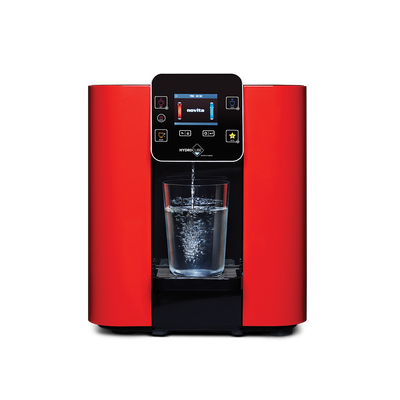 A novita HydroCube™ Hot/Cold Water Dispenser W29 with 3 Years Warranty with a glass of water.