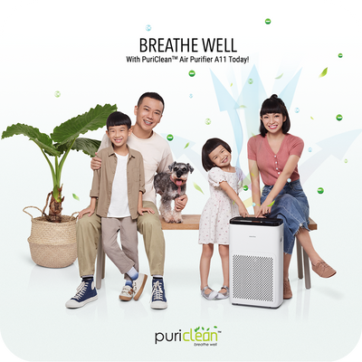 A family is posing in front of a novita purify air purifier.