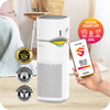 A person holding a smart phone next to a novita Air Purifier + Humidifier A2+H for an effective indoor air cleaning solution.