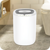 A white novita Dehumidifier ND298 in a bathroom that effectively removes impurities and odors.