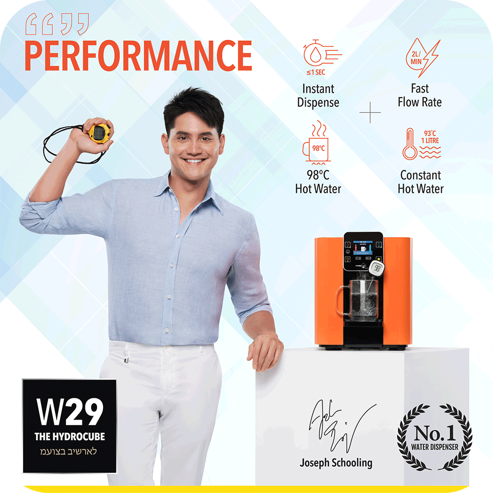 A man is posing in front of the novita HydroCube™ Hot/Cold Water Dispenser W29 with 3 Years Warranty.
