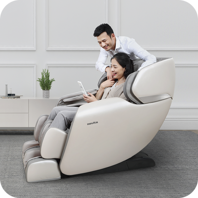 A man and woman sitting in a novita Massage Chair B11.