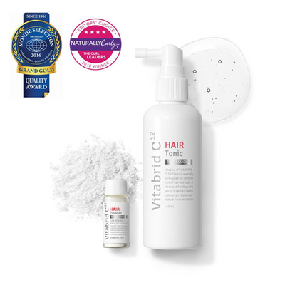 A bottle of Vitabrid Restore & Regrowth Set: Vitabrid C¹² Scalp⁺ Shampoo + Vitabrid C¹² HAIR Tonic Set: Professional and a bottle of white powder.