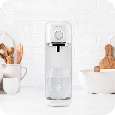 A novita SG Instant Hot Water Dispenser W18 - The Simplest with a glass of water next to it.
