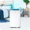 A white novita Coolplus™ 3-In-1 Portable Air Conditioner NAC12000UV in a bedroom.