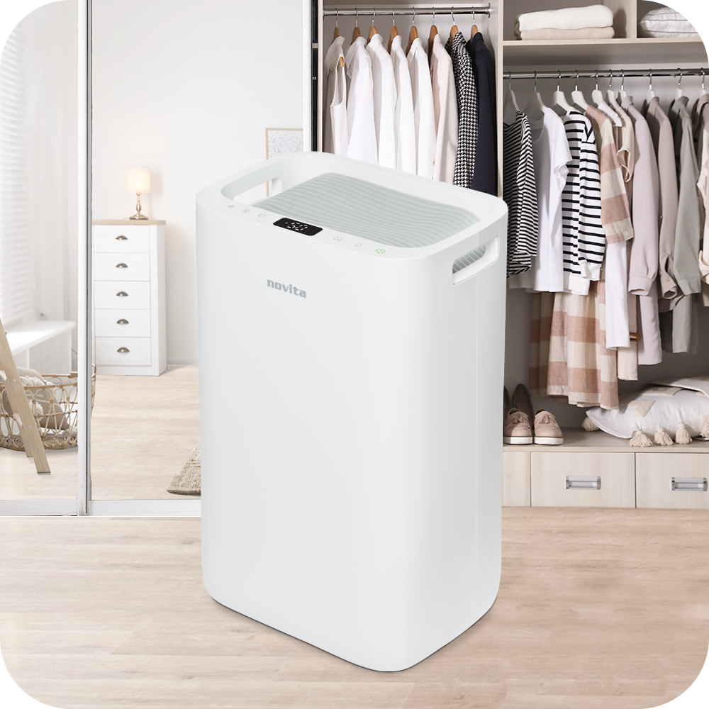 Novita Air Purifier + Dehumidifier The 2-In-1 ND25.5 in a room with clothes.