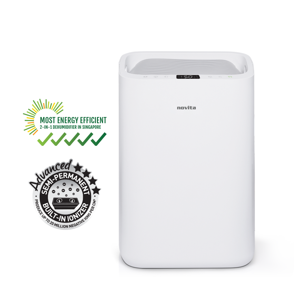 A white novita Dehumidifier + Air Purifier The 2-In-1 ND25.5 with a basket of towels next to it.