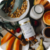 A bowl of granola, oranges, bananas and PURITI Premium Raw Manuka Honey UMF 15+ | MGO 550 from novita SG.