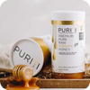 Novita SG presents PWP Offer: PURITI Premium Raw Manuka Honey UMF 5+ | MGO 100 on a wooden tray.