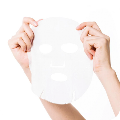 A woman's hands holding a Vitabrid Dual Mask: Age-Defying & Firming (Box of 5 Pcs) on a white background.