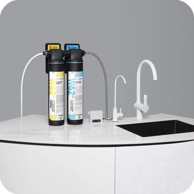 A novita 15” Undersink Filtration System W62 Plus– The Home • Ultra with two faucets and a water filter.