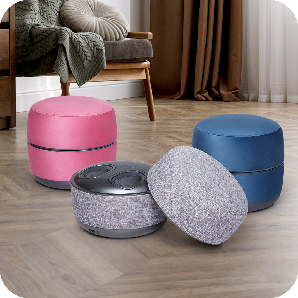 Four different colored novita Foot Massager B8s sitting on a wooden floor.