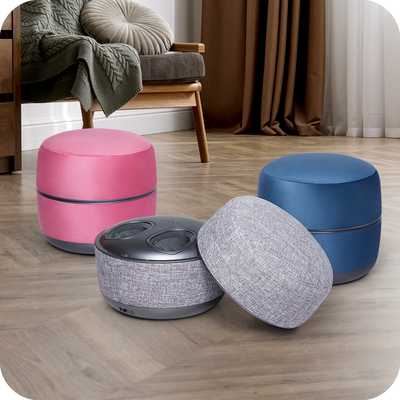 Four different colored novita Foot Massager B8s sitting on a wooden floor.