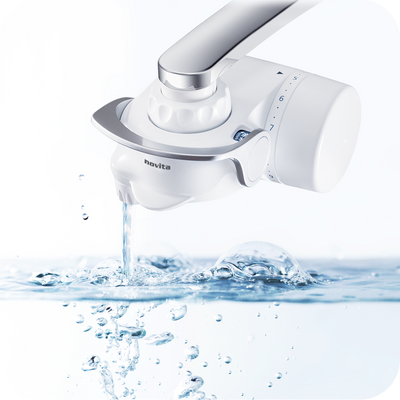 A novita NP180 Faucet Water Purifier with Filter Pack, with water coming out of it.
