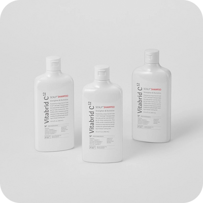 Three bottles of Vitabrid C¹² Scalp+ Shampoo on a white background.